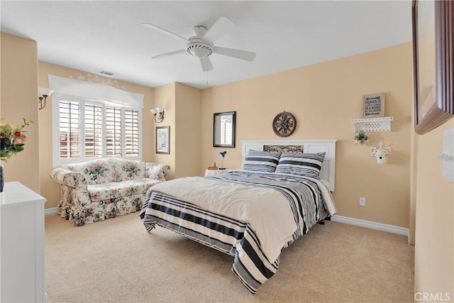 bedroom with carpet, baseboards, and a ceiling fan