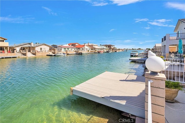 dock area featuring a water view and a residential view