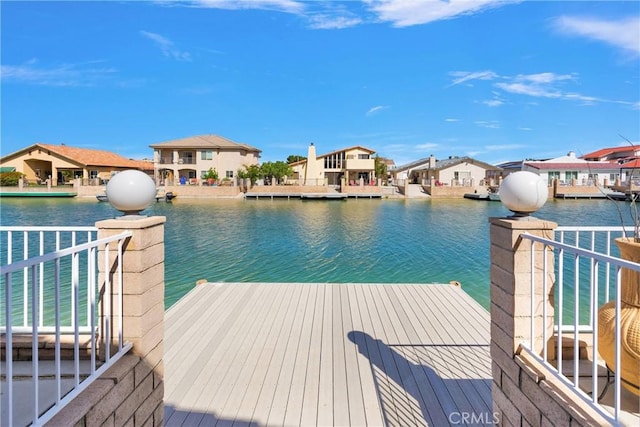 dock area with a residential view and a water view