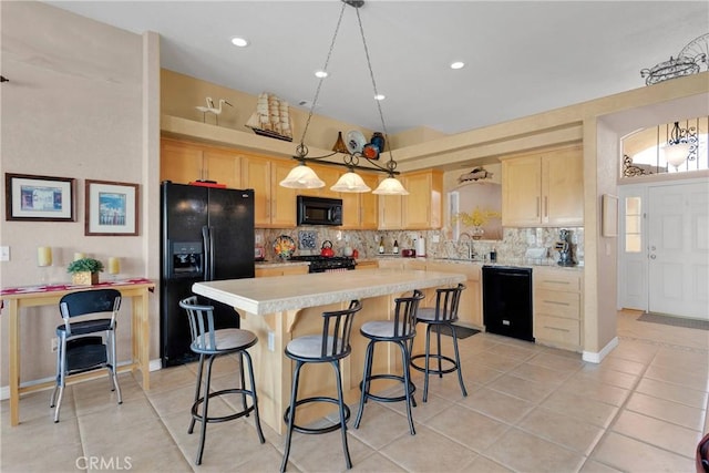 kitchen featuring black appliances, light brown cabinetry, light countertops, light tile patterned floors, and vaulted ceiling