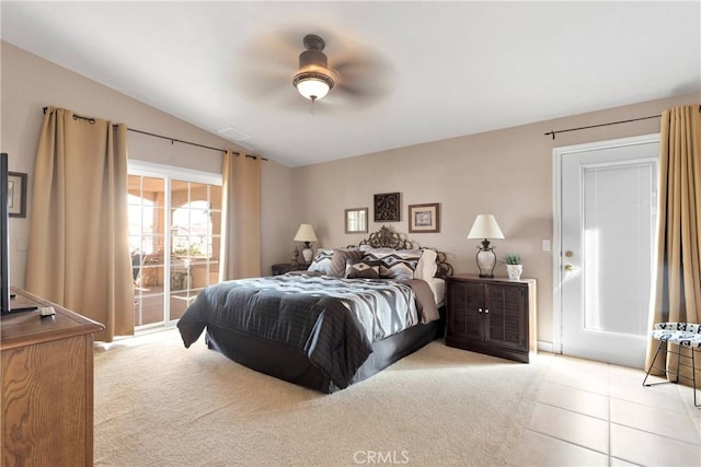tiled bedroom with access to exterior, a ceiling fan, and vaulted ceiling