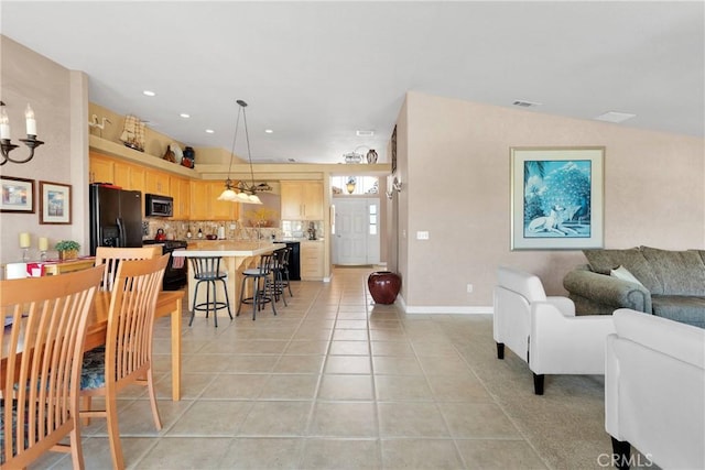 dining area featuring light tile patterned flooring, baseboards, and recessed lighting