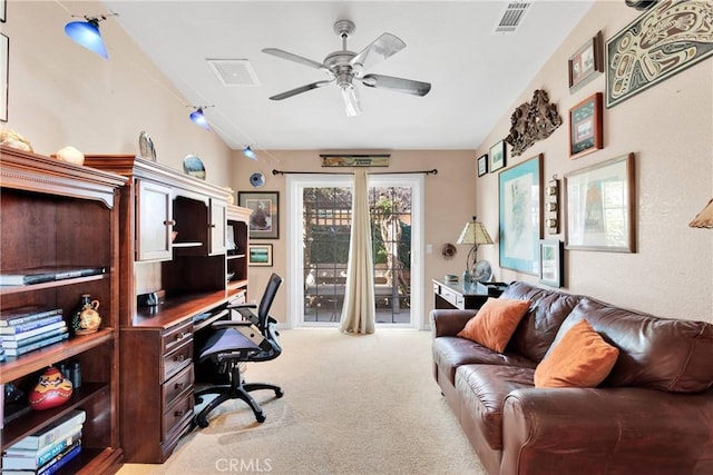 carpeted office space featuring lofted ceiling and ceiling fan