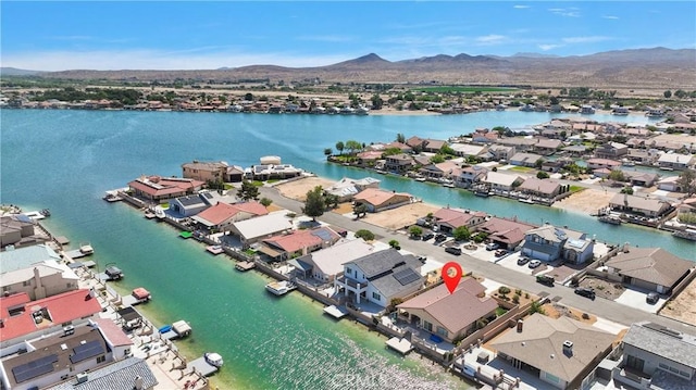 aerial view of residential area featuring a water and mountain view