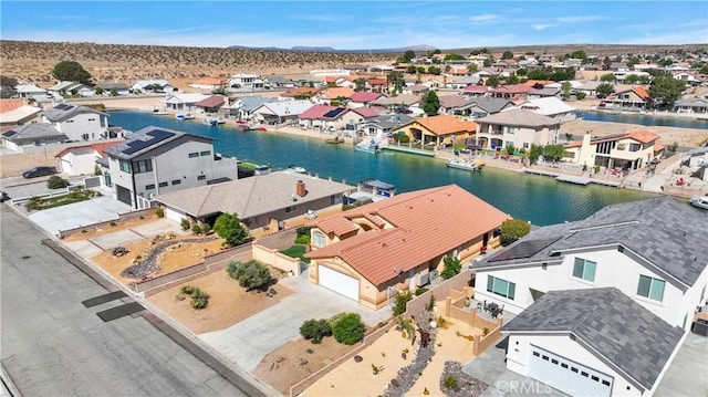 aerial view of residential area featuring a water and mountain view
