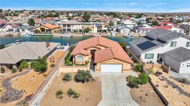 aerial view of residential area featuring a nearby body of water