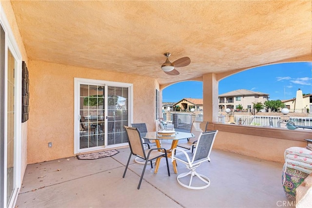view of patio with ceiling fan, a residential view, and outdoor dining area