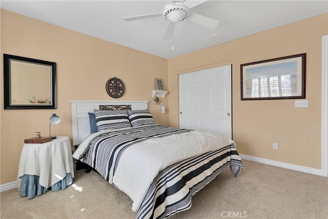 carpeted bedroom with baseboards and a ceiling fan