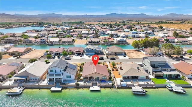 aerial view of residential area featuring a water and mountain view