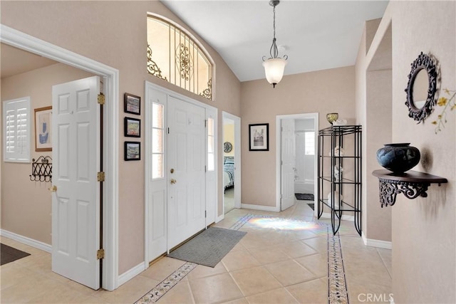 entryway featuring light tile patterned flooring and baseboards