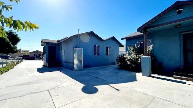 2305 Walter St, Huntington Park, CA 90255 - view of side of property featuring stucco siding and a patio area