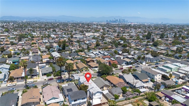 aerial overview of property's location featuring a mountain backdrop and nearby suburban area
