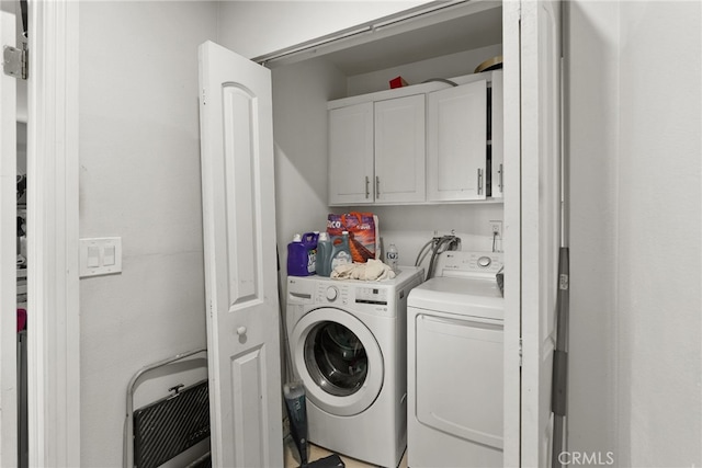 laundry room with cabinet space and washing machine and dryer