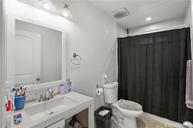 bathroom with toilet, vanity, tile patterned floors, and curtained shower