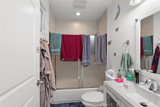 full bath with toilet, vanity, and enclosed tub / shower combo