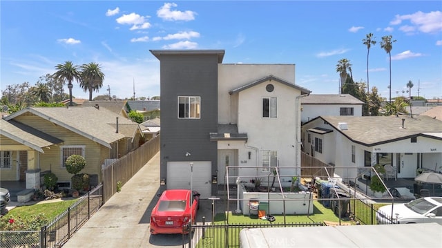 view of front of house with concrete driveway, a garage, stucco siding, and a residential view