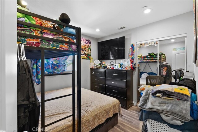 bedroom with wood finished floors and recessed lighting