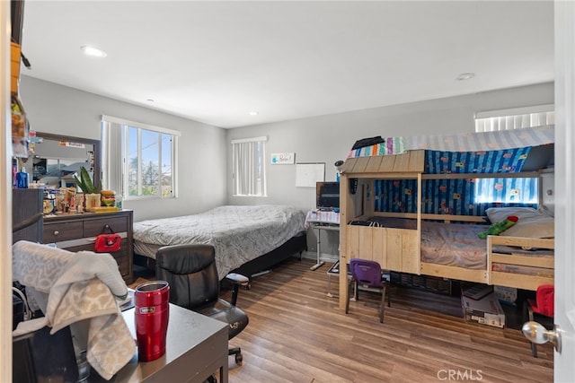 bedroom with wood finished floors and recessed lighting