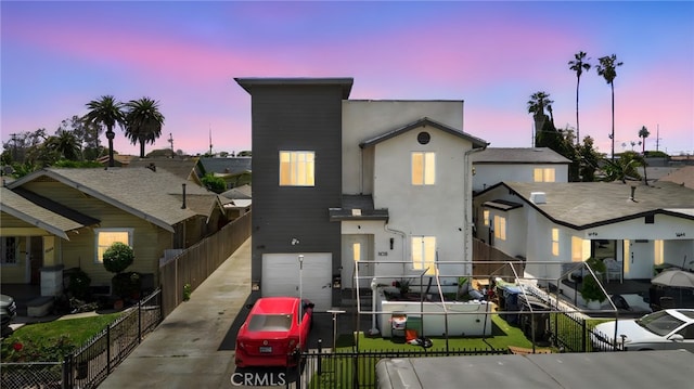 view of front of house with stucco siding and a garage