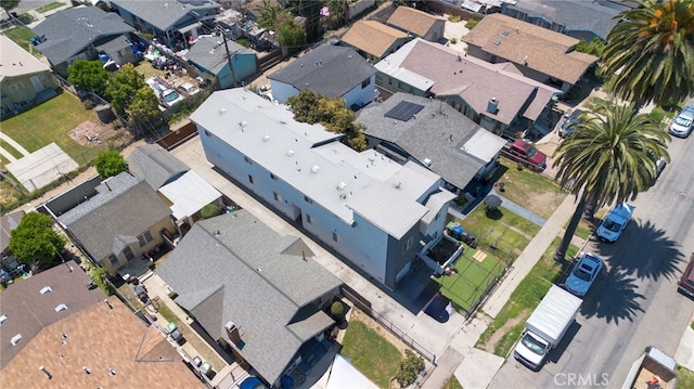 aerial view of property and surrounding area featuring nearby suburban area