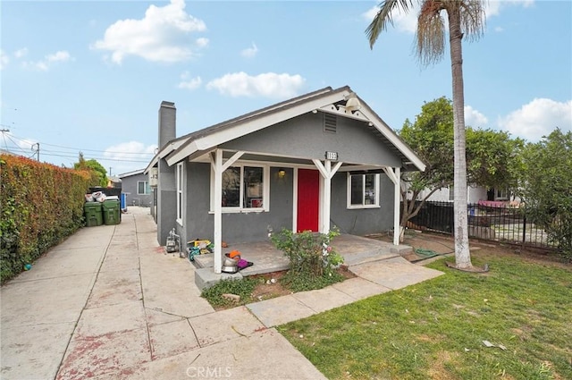 3322 W 66th St, Los Angeles, CA 90043 - bungalow-style home with stucco siding, covered porch, and a chimney