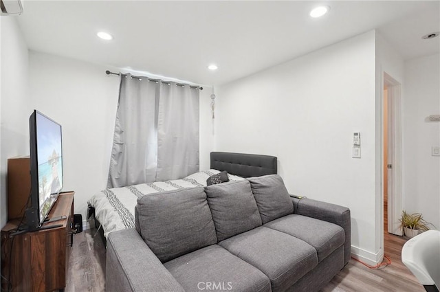 3322 W 66th St, Los Angeles, CA 90043 - bedroom with wood finished floors, recessed lighting, a wall unit AC, and baseboards
