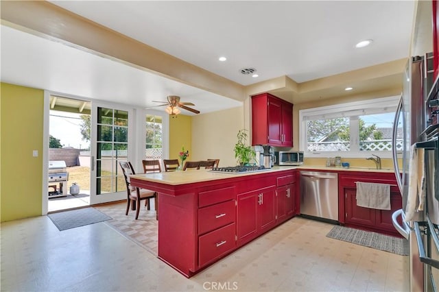 1961 W 187th Pl, Torrance, CA 90504 - kitchen with appliances with stainless steel finishes, red cabinets, light flooring, a peninsula, and recessed lighting