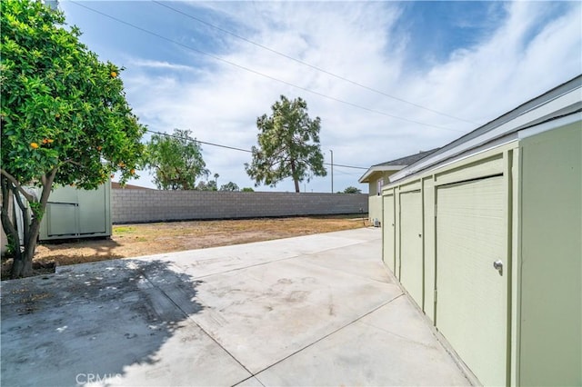 1961 W 187th Pl, Torrance, CA 90504 - view of patio featuring a storage unit, a fenced backyard, and an outdoor structure