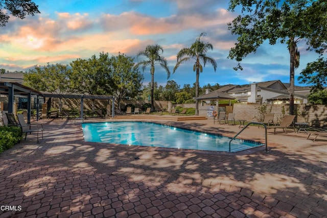 2451 Manet Ln, Simi Valley, CA 93063 - pool at dusk with a community pool, a pergola, a patio area, a gazebo, and fence