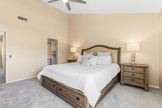 2451 Manet Ln, Simi Valley, CA 93063 - bedroom with light colored carpet, a walk in closet, baseboards, a ceiling fan, and high vaulted ceiling