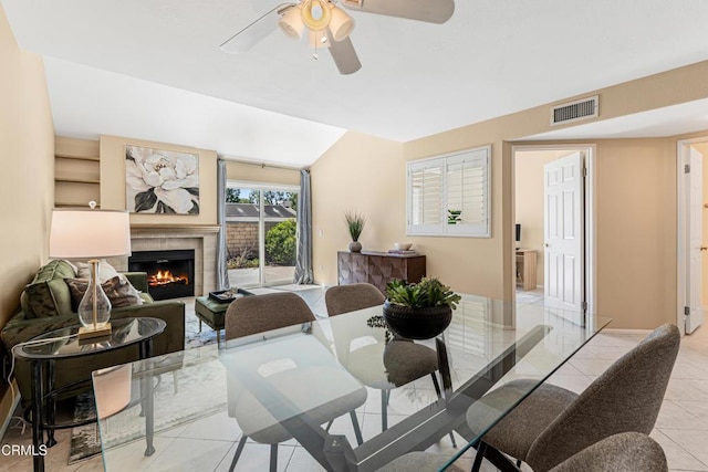 2451 Manet Ln, Simi Valley, CA 93063 - dining area featuring light tile patterned flooring, a glass covered fireplace, and a ceiling fan