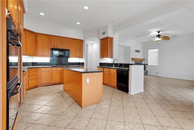 34113 Castle Pines Dr, Yucaipa, CA 92399 - kitchen with black appliances, dark countertops, ceiling fan, a center island, and light tile patterned floors