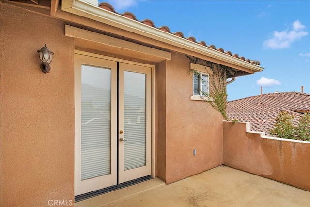 34113 Castle Pines Dr, Yucaipa, CA 92399 - property entrance featuring stucco siding, french doors, and a balcony