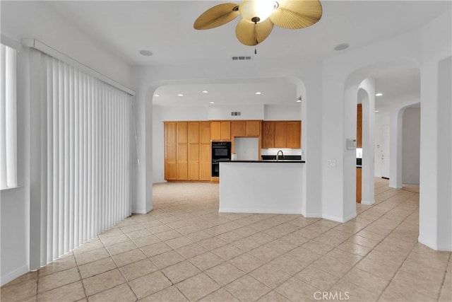 34113 Castle Pines Dr, Yucaipa, CA 92399 - unfurnished living room with a sink, recessed lighting, a ceiling fan, arched walkways, and light tile patterned flooring