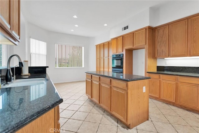 34113 Castle Pines Dr, Yucaipa, CA 92399 - kitchen featuring black oven, a sink, light tile patterned flooring, dark stone countertops, and recessed lighting