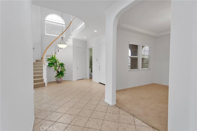 34113 Castle Pines Dr, Yucaipa, CA 92399 - entryway with healthy amount of natural light, stairway, light tile patterned floors, light carpet, and recessed lighting