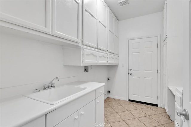 34113 Castle Pines Dr, Yucaipa, CA 92399 - laundry area with hookup for a washing machine, cabinet space, electric dryer hookup, light tile patterned flooring, and baseboards