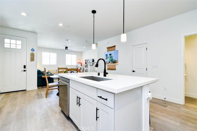 1053 Tiburon Way, San Luis Obispo, CA 93401 - kitchen featuring a sink, dishwasher, light wood finished floors, hanging light fixtures, and light countertops