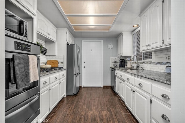 1729 Amelia Ave, San Pedro, CA 90731 - kitchen featuring a sink, appliances with stainless steel finishes, a warming drawer, white cabinetry, and light stone countertops