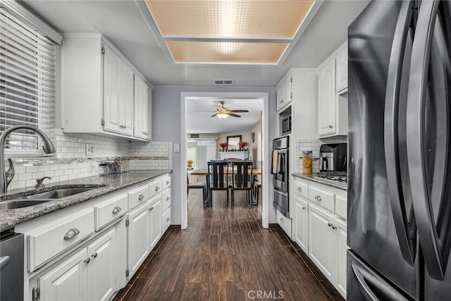 1729 Amelia Ave, San Pedro, CA 90731 - kitchen featuring stainless steel appliances, a sink, a warming drawer, ceiling fan, and backsplash