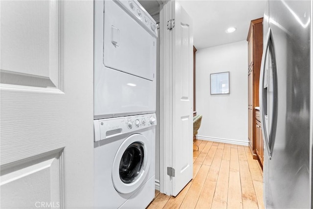 201 Bay Shore Ave Unit 209, Long Beach, CA 90803 - washroom featuring estacked washer and dryer, light wood-type flooring, baseboards, and recessed lighting