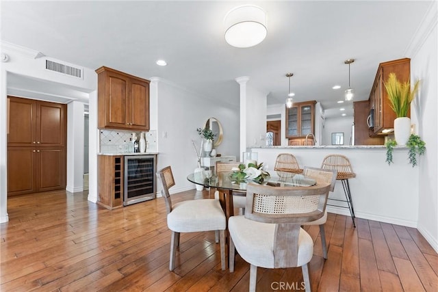 201 Bay Shore Ave Unit 209, Long Beach, CA 90803 - dining space with wine cooler, hardwood / wood-style flooring, ornate columns, baseboards, and recessed lighting
