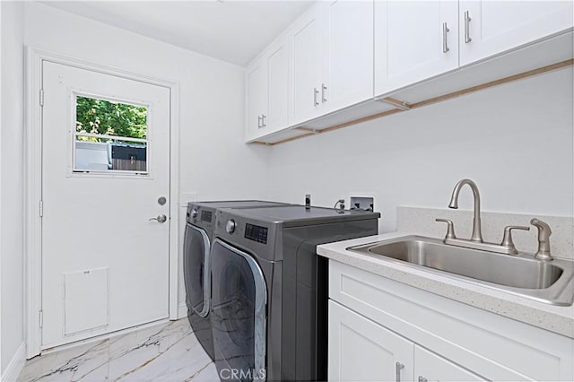 28 Brownsbury Rd, Laguna Niguel, CA 92677 - laundry area with cabinet space, light marble finish flooring, washer and dryer, and baseboards