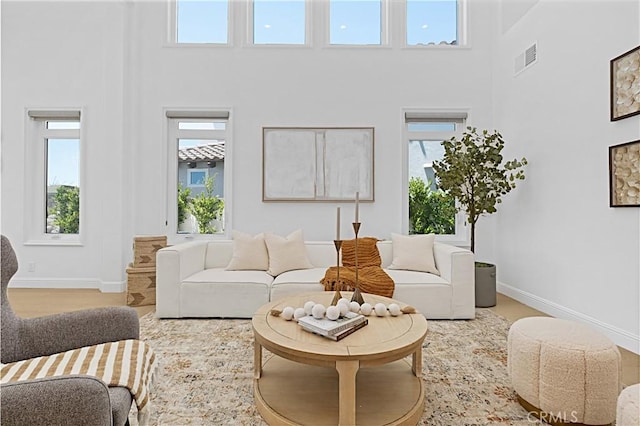 28 Brownsbury Rd, Laguna Niguel, CA 92677 - living room featuring a high ceiling and baseboards