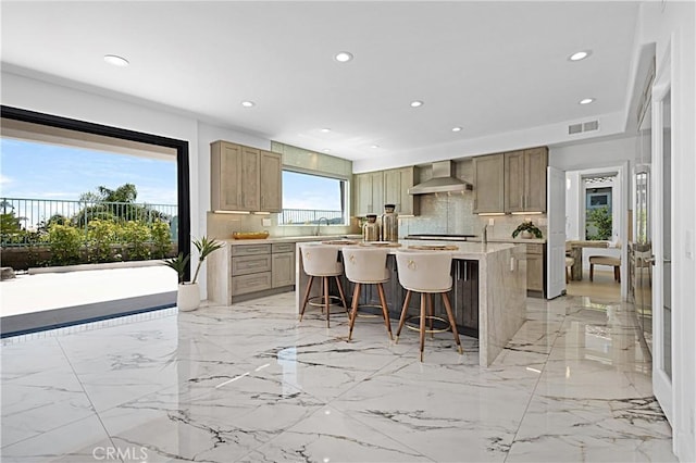 28 Brownsbury Rd, Laguna Niguel, CA 92677 - kitchen featuring wall chimney exhaust hood, decorative backsplash, a breakfast bar area, light marble finish floors, and a center island