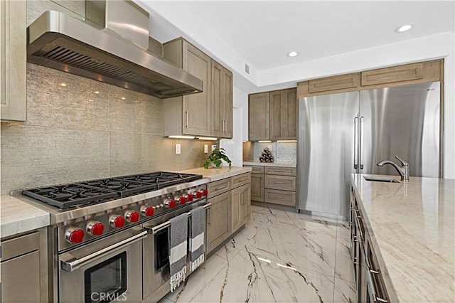 28 Brownsbury Rd, Laguna Niguel, CA 92677 - kitchen featuring high end appliances, wall chimney exhaust hood, light marble finish flooring, a sink, and tasteful backsplash