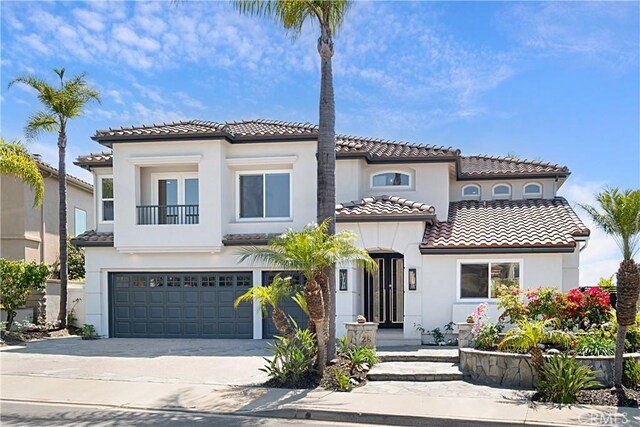 28 Brownsbury Rd, Laguna Niguel, CA 92677 - mediterranean / spanish-style house featuring a tiled roof, an attached garage, stucco siding, concrete driveway, and a balcony