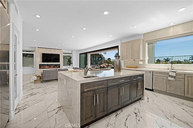 28 Brownsbury Rd, Laguna Niguel, CA 92677 - kitchen featuring a sink, recessed lighting, an island with sink, a large fireplace, and light marble finish flooring