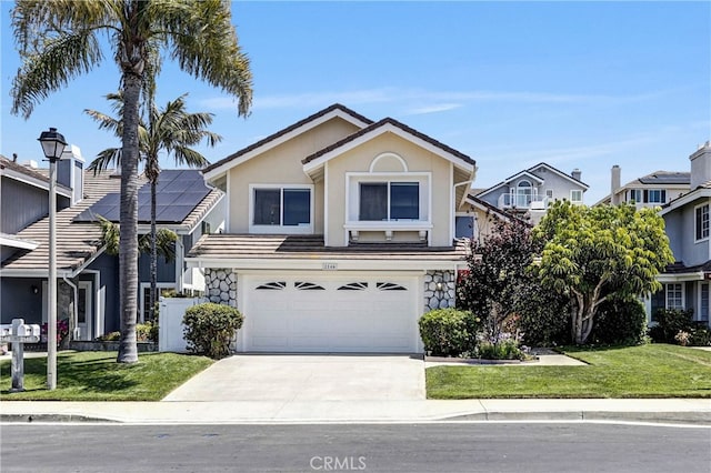 2146 Via Aguila, San Clemente, CA 92673 - traditional-style house with concrete driveway, an attached garage, a front yard, stucco siding, and stone siding