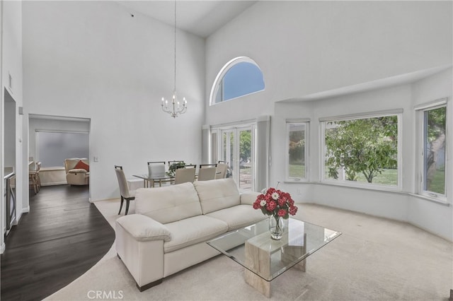 2146 Via Aguila, San Clemente, CA 92673 - living area with a towering ceiling, healthy amount of natural light, a chandelier, and wood finished floors